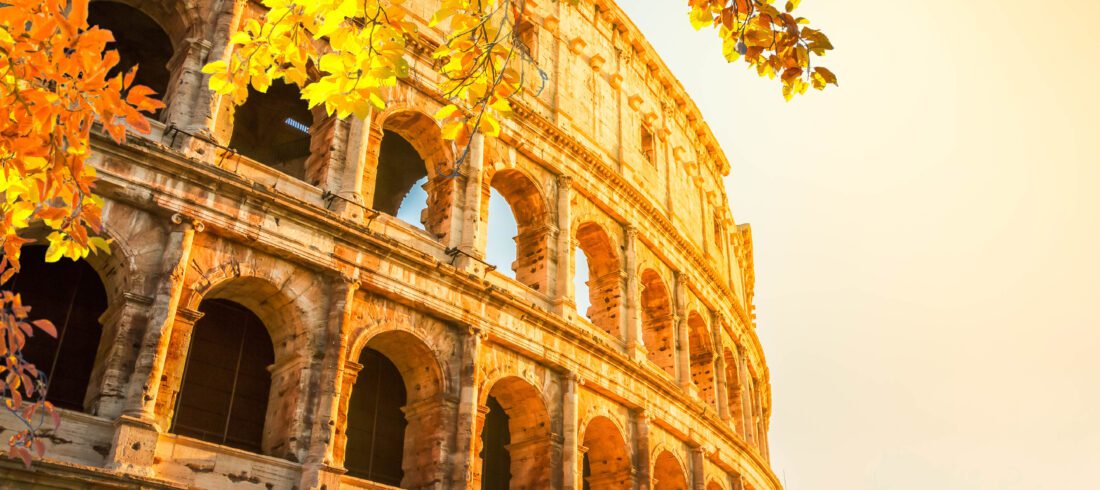 Italy Tours From USA / Ruins of Colosseum at sunrise light in Rome, Italy at fall