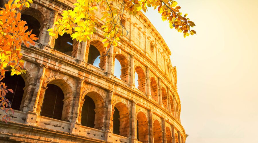 Italy Tours From USA / Ruins of Colosseum at sunrise light in Rome, Italy at fall