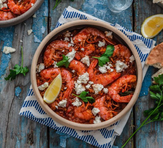 Prawns in tomato sauce with feta cheese, copy space.